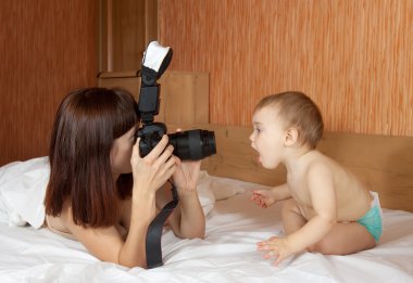 Mother with baby takes photo clipart