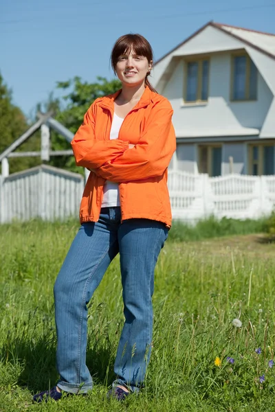 stock image Happy woman in front of her residence