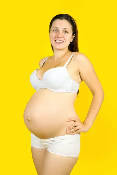 Donna incinta sopra il giallo — Foto Stock