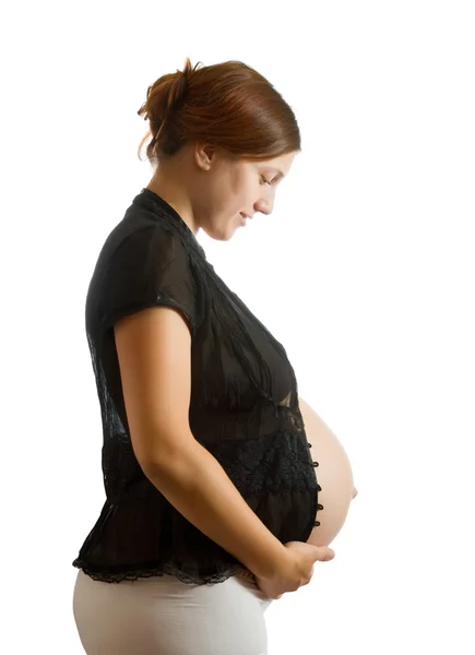 Gravid kvinna ser magen — Stockfoto