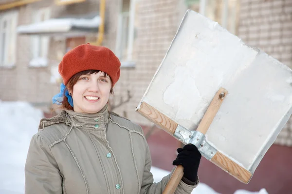Woman with shovel in winter — Stock Photo, Image