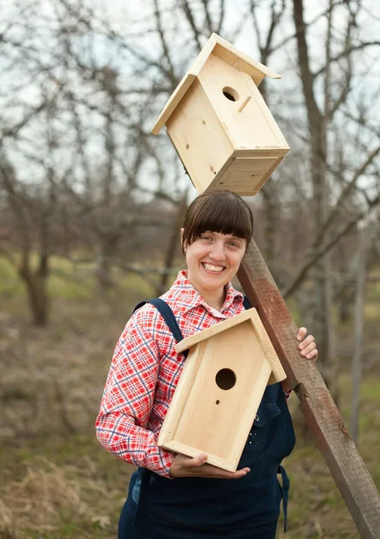Woman with two birdhouses — Stock Photo, Image