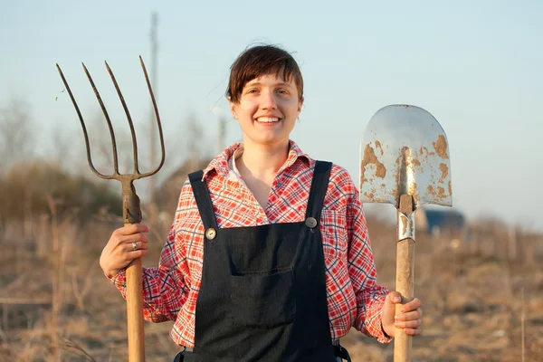 Happy farmer with spade and pitchfork — Stock Photo, Image