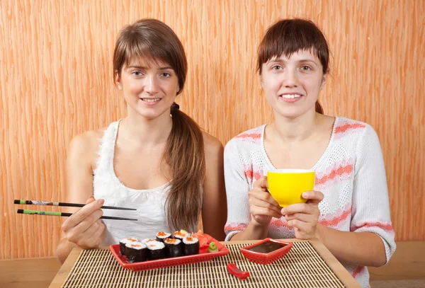 Mulheres comendo rolos de sushi — Fotografia de Stock