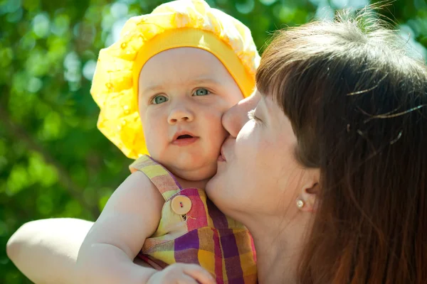 Happy mother kissing baby daughter — Stock Photo, Image