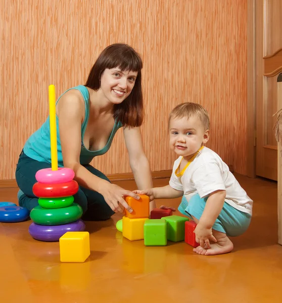 Mãe e bebê brinca com brinquedos — Fotografia de Stock