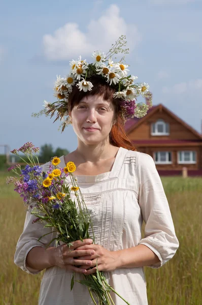 Woman in camomile chaplet Stock Image