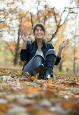 Happy girl in autumn park clipart