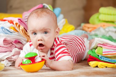 Happy baby with baby's things clipart
