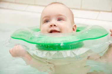 Baby swimming in bath clipart