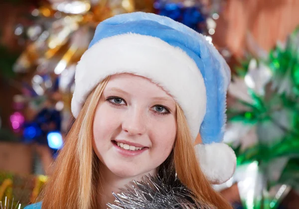 Girl in blue Christmas hat — Stock Photo, Image