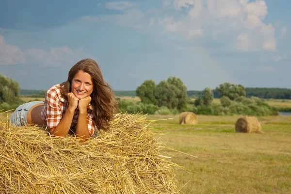 Girl on straw bale — Stock Photo, Image