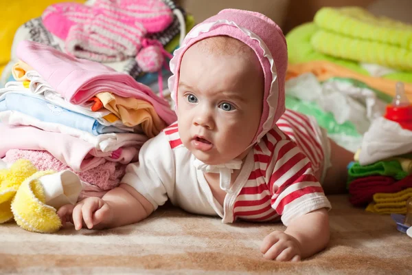Baby girl with children's clothes — Stock Photo, Image