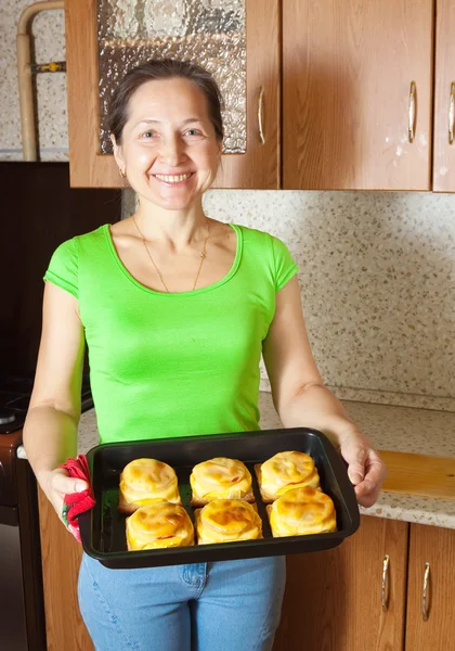 Woman with cooked baked stuffed vegetable marrow — Stock Photo, Image