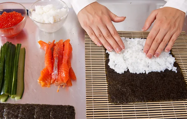 stock image Cook making sushi rolls