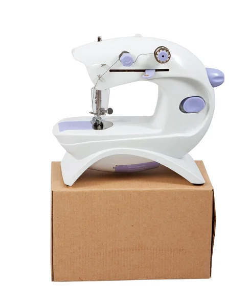 Sewing machine on packed box — Stock Photo, Image