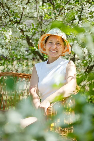 Mature woman in spring garden — Stock Photo, Image