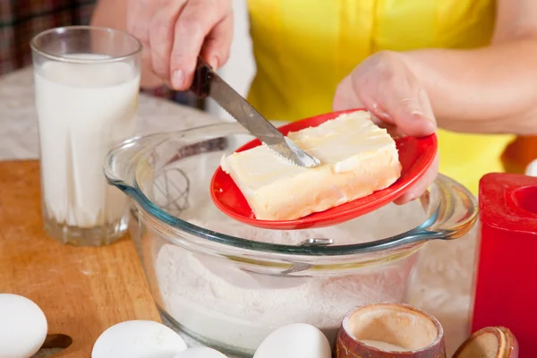 stock image Cook hands adds margarine into dough