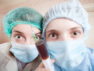 Wide angle shot of two young doctors clipart