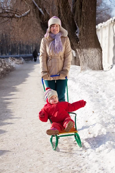 Mother with toddler on sled — Stock Photo, Image
