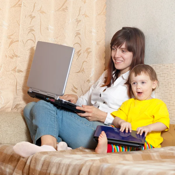 Happy mother and child with laptops — Stock Photo, Image