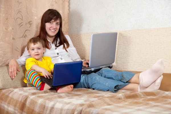 Happy woman and child with laptops — Stock Photo, Image