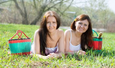 Happy women relaxing in park clipart