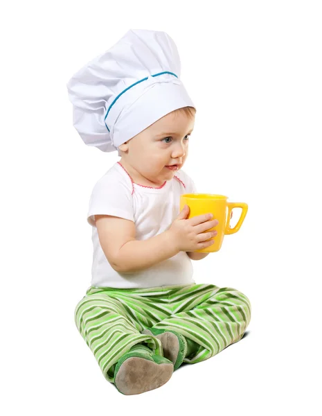 Baby cook in toque with cup — Stock Photo, Image