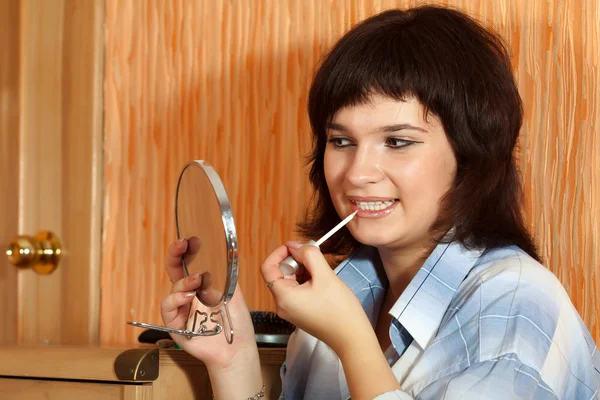 Brunette girl paints lips — Stock Photo, Image