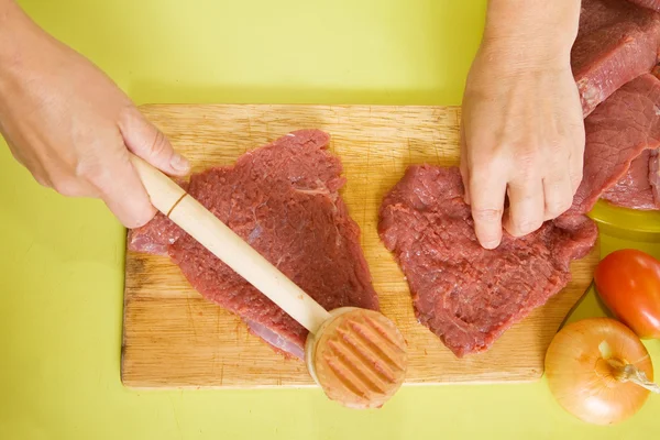 Cook hands making tenderized steak — Stock Photo, Image