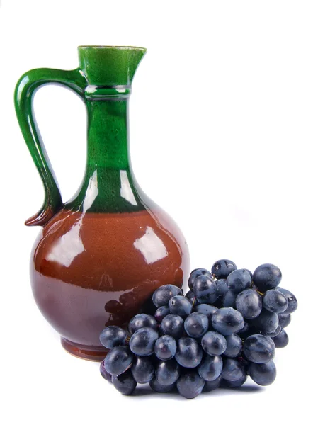 Old ceramic decanter with grapes — Stock Photo, Image