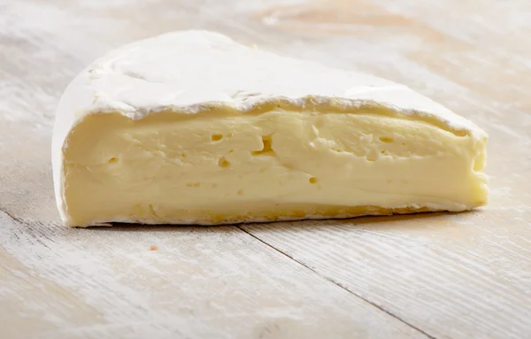 Queijo em uma mesa de madeira — Fotografia de Stock