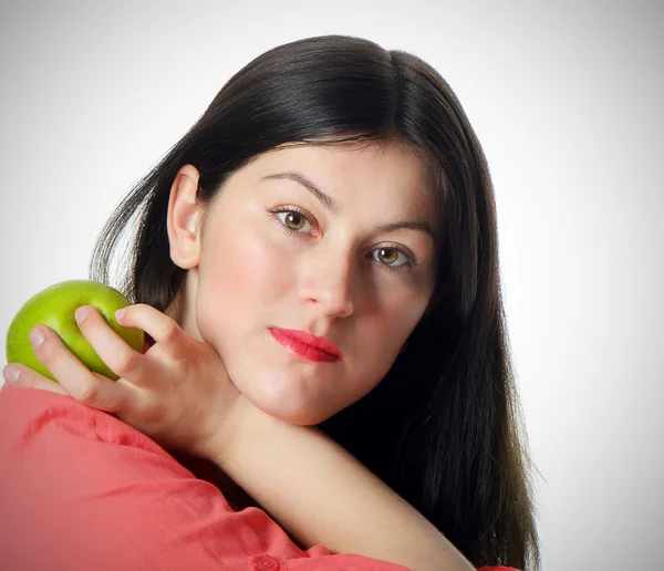 Mladá žena se zeleným jablkem — Stock fotografie