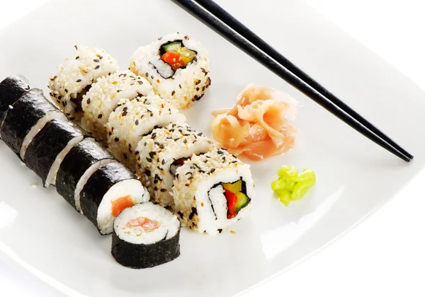 stock image Sushi rolls, wasabi and ginger on the white plate