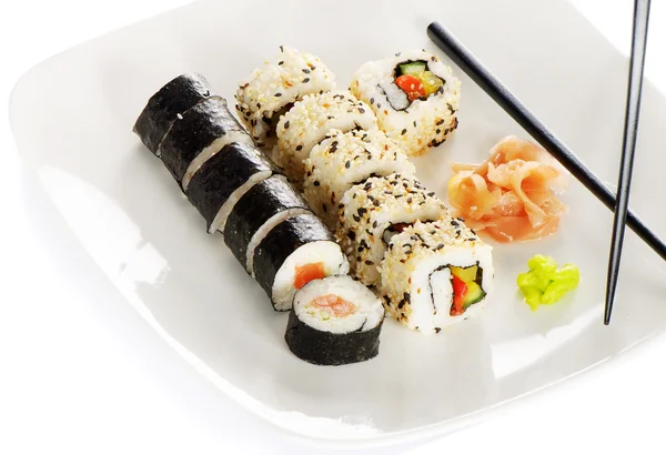 stock image Sushi rolls, wasabi and ginger on the white plate