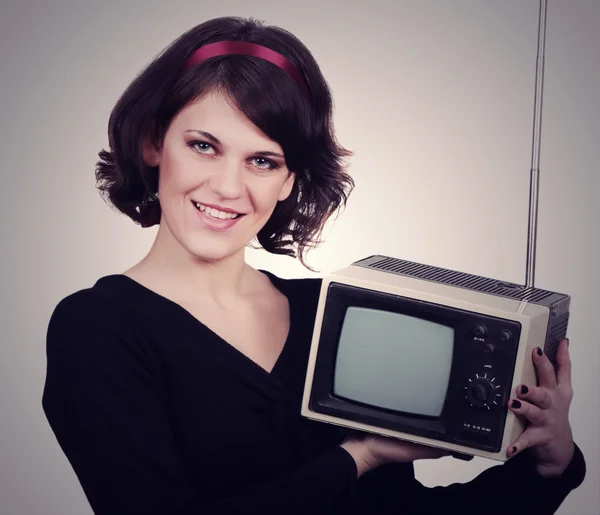 Young woman with tv in retro style — Stock Photo, Image