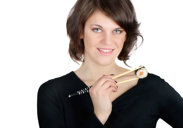 Kvinna anläggning sushi med pinnar — Stockfoto
