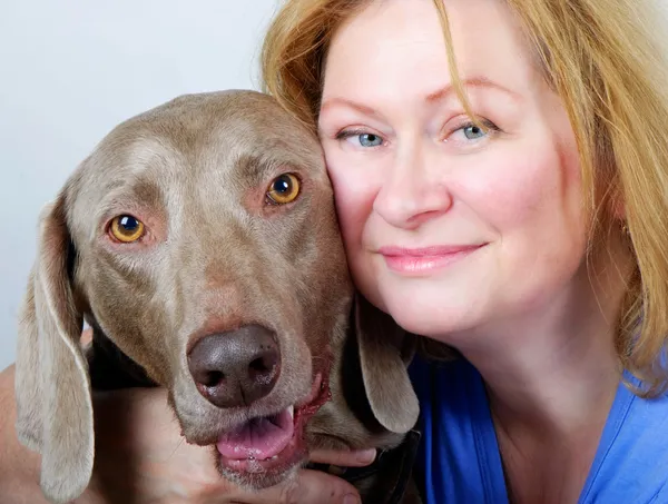 Woman hugging and comforting dog — Stock Photo, Image