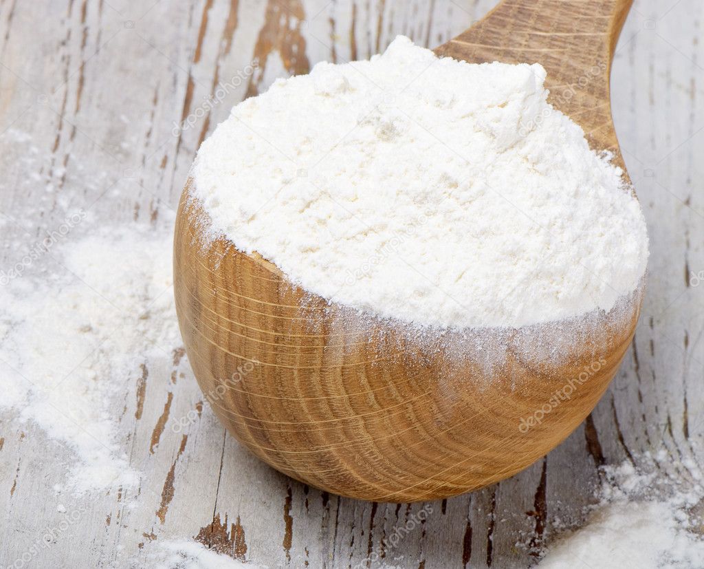 Wooden spoon with flour