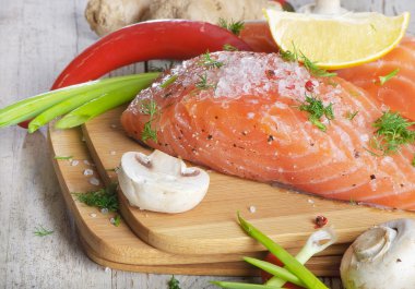 Fresh salmon steak with vegetables clipart