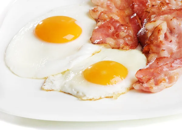 Traditional breakfast with bacon and fried eggs Stock Photo