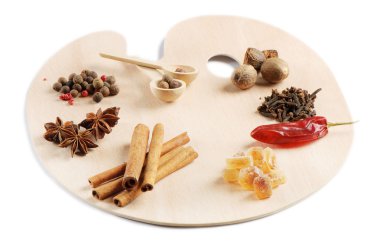 Spices on a wooden palette isolated on white clipart