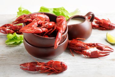 Boiled crawfish with lemon and fresh salad clipart