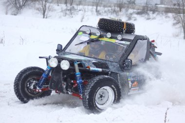 The quad bike's drivers ride over snow track clipart