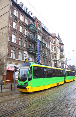 Modern tram on a street of Poznan clipart