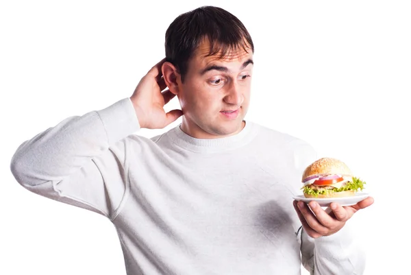 Człowiek ma hamburger na białym tle — Zdjęcie stockowe