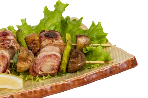 Bacon wrapped grilled Scallops with mushrooms and bacon Royalty Free Stock Photos
