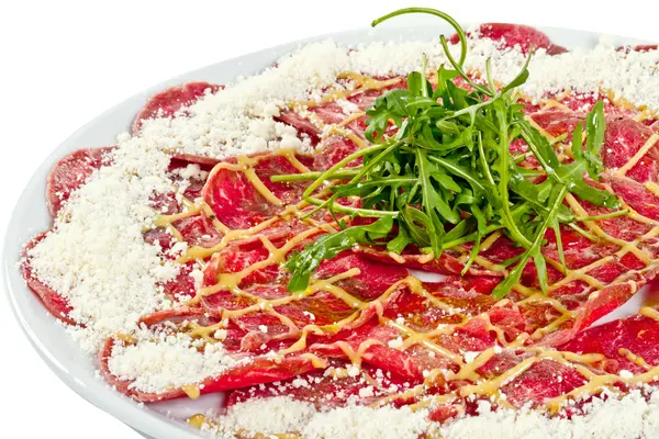 stock image Meat (beef) Carpaccio with Parmesan Cheese and ruccola