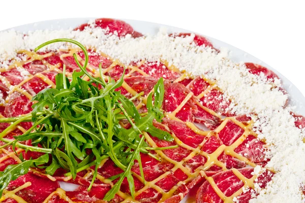 stock image Meat (beef) Carpaccio with Parmesan Cheese and ruccola