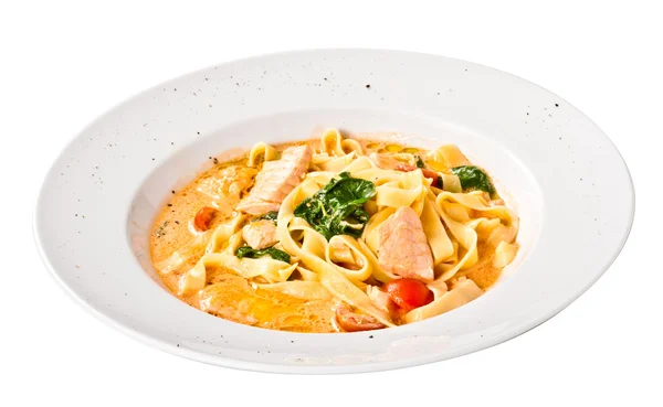 Tasty pasta with cream, salmon, cheese and parsley close up — Stock Photo, Image